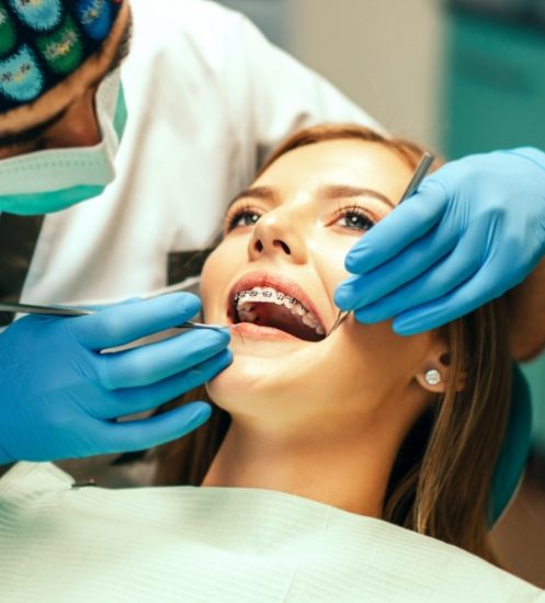 dentist-examine-female-patient-with-braces-denal-office